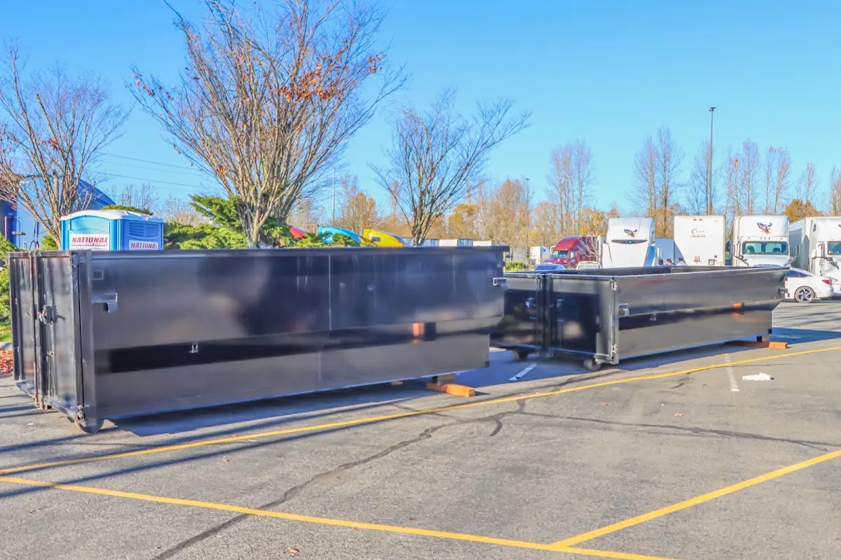 Professional dumpster rental service with roll-off container on residential driveway in Raytown